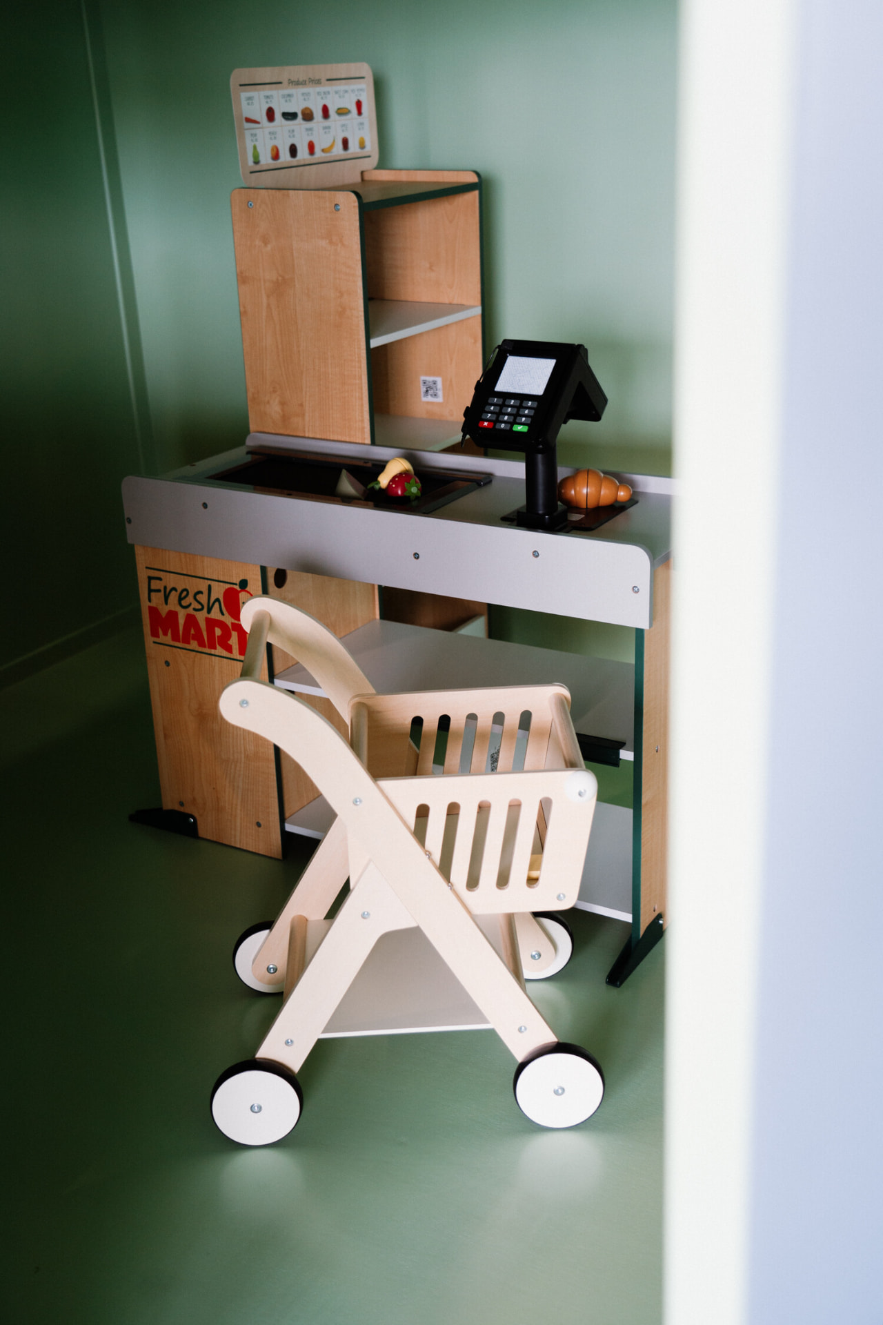 Fresh Mart pretend grocery store with wooden cart